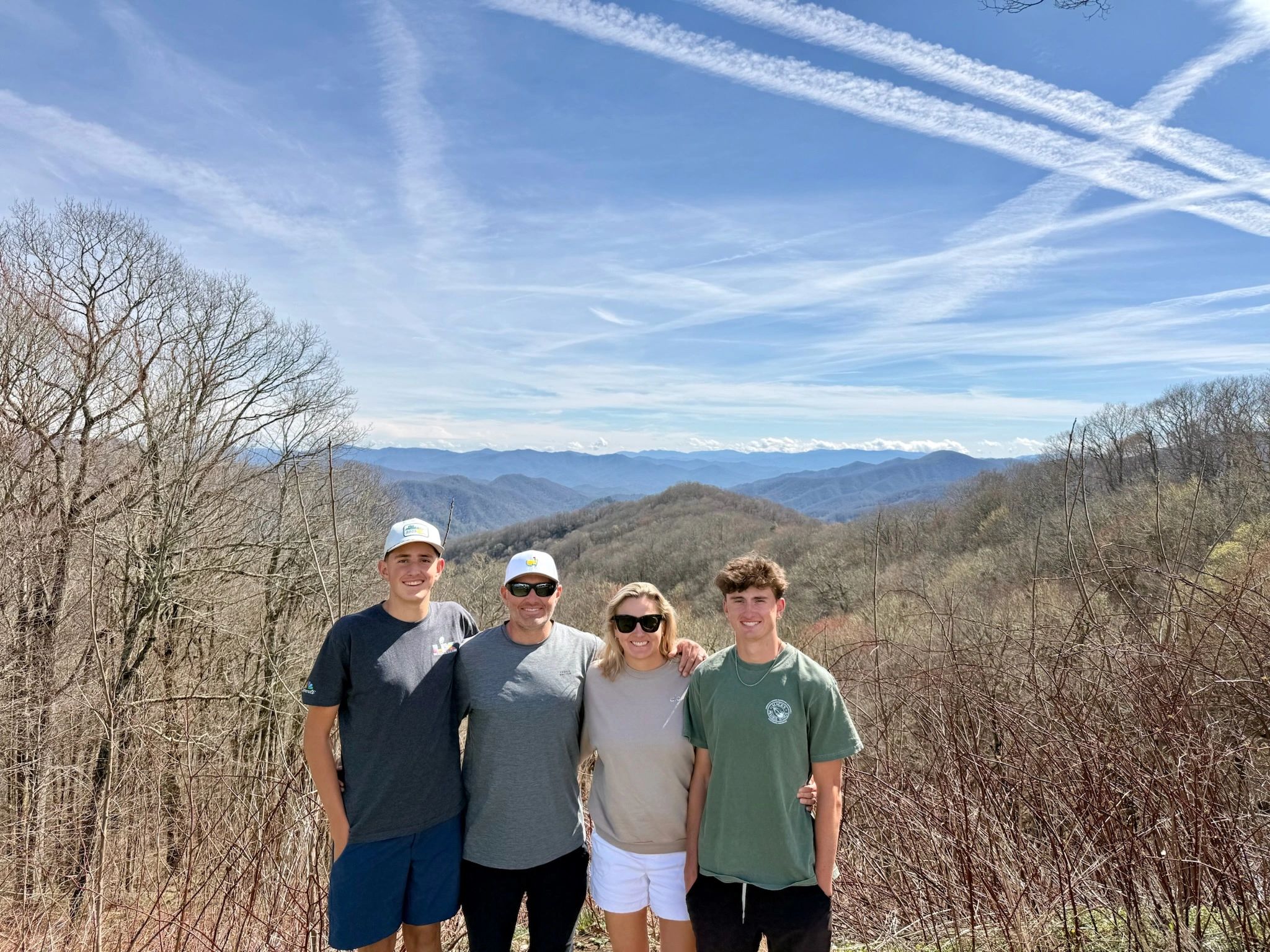 Family group on a mountain overlook with scenic vista